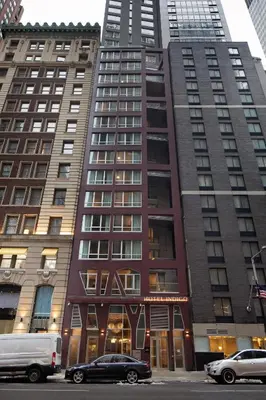 a tall building with cars parked in front of it at Hotel Indigo NYC Downtown - Wall Street by IHG in New York