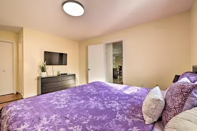 a bedroom with a purple bed and a tv at Deck and Backyard Tobyhanna Family Home in Tobyhanna