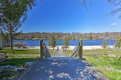 a wooden ramp with a view of a lake at Deck and Backyard Tobyhanna Family Home in Tobyhanna
