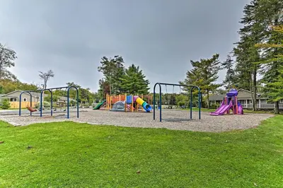 a park with a playground with slides at Deck and Backyard Tobyhanna Family Home in Tobyhanna
