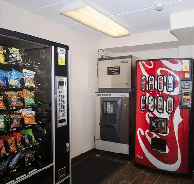 a coca cola refrigerator and a soda machine in a store at Red Roof Inn Philadelphia - Oxford Valley in Langhorne