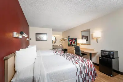 a hotel room with a bed and a desk at Red Roof Inn Philadelphia - Oxford Valley in Langhorne