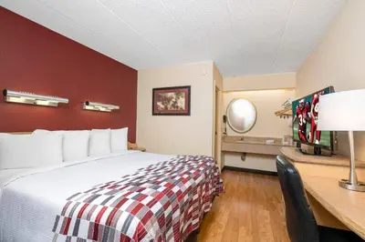 a hotel room with a bed and a desk at Red Roof Inn Philadelphia - Oxford Valley in Langhorne