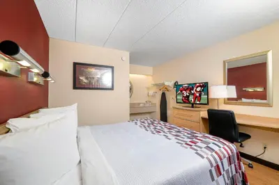 a hotel room with a bed and a desk at Red Roof Inn Philadelphia - Oxford Valley in Langhorne