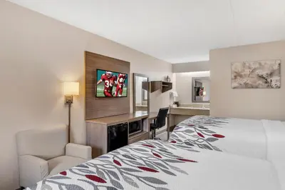 a hotel room with a bed and a desk at Red Roof Inn Parsippany in Parsippany