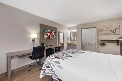a bedroom with a bed and a desk and a computer at Red Roof Inn Parsippany in Parsippany