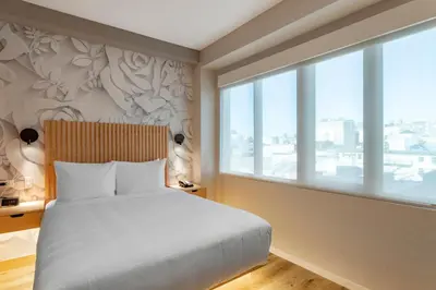 a bedroom with a bed and a large window at Best Western Plus Soho Hotel in New York
