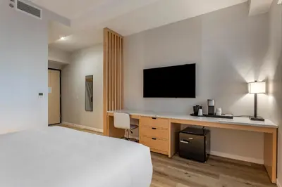 a hotel room with a bed and a desk with a tv at Best Western Plus Soho Hotel in New York