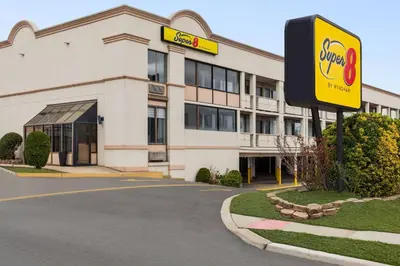 a building with a coke sign in front of it at Super 8 by Wyndham Meadowlands in Carlstadt