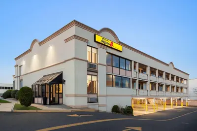 a hotel with a sign on the front of it at Super 8 by Wyndham Meadowlands in Carlstadt