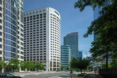 a tall white building in the middle of a city at The Westin Jersey City Newport in Jersey City
