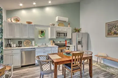 a kitchen with white cabinets and a wooden table and chairs at Hike and Ski! Blue Heron Brodheadsville Cottage in Brodheadsville