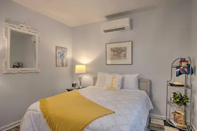 a bedroom with a bed with a yellow blanket on it at Hike and Ski! Blue Heron Brodheadsville Cottage in Brodheadsville