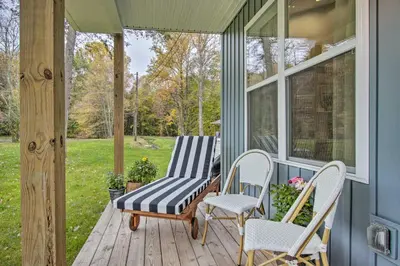 a porch with two chairs and a bench at Hike and Ski! Blue Heron Brodheadsville Cottage in Brodheadsville