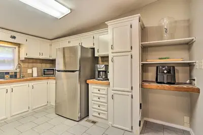 a kitchen with white cabinets and a stainless steel refrigerator at Port Jervis Home about 8 Acres with Mountain View! in Port Jervis