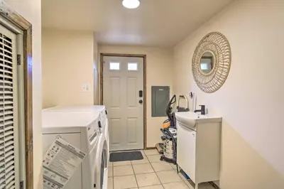 a kitchen with a washer and dryer next to a door at Port Jervis Home about 8 Acres with Mountain View! in Port Jervis