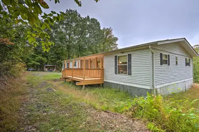 a small white house with a porch on a field at Port Jervis Home about 8 Acres with Mountain View! in Port Jervis