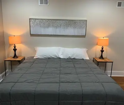 a bedroom with a large bed with two lamps at Center City Roofdeck Hot Tub w Garage in Philadelphia
