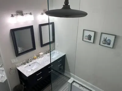 a bathroom with a sink and a mirror at Center City Roofdeck Hot Tub w Garage in Philadelphia
