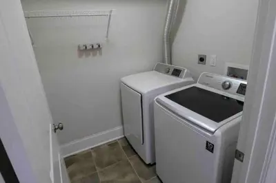 a white washer and dryer in a small room at Center City Roofdeck Hot Tub w Garage in Philadelphia