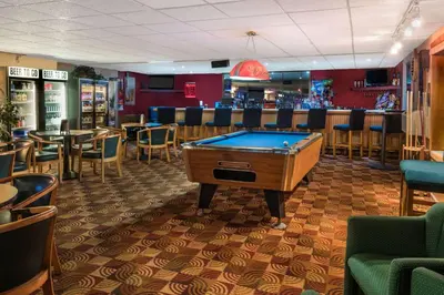 a pool table in a restaurant with a bar at Days Inn By Wyndham Carlisle North in Carlisle