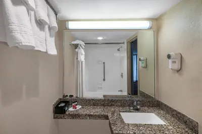 a bathroom with a sink and a large mirror at Days Inn By Wyndham Carlisle North in Carlisle