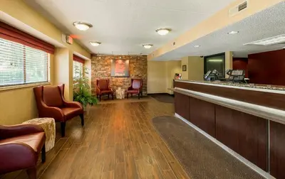a lobby of a hospital with chairs and a bar at Red Roof Inn PLUS+ Wilmington - Newark in Christiana