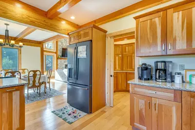 a kitchen with wooden cabinets and a black refrigerator at Spacious and Secluded Forksville Home Fire Pit in Forksville