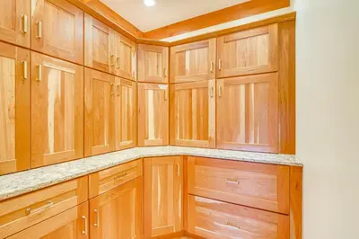 a kitchen with wooden cabinets and granite counter tops at Spacious and Secluded Forksville Home Fire Pit in Forksville