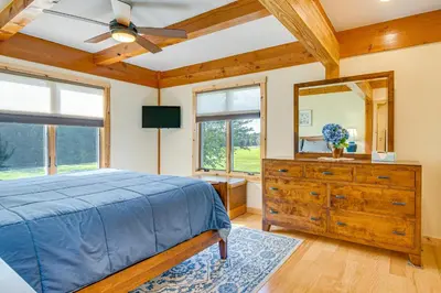 a bedroom with a bed and a dresser and a mirror at Spacious and Secluded Forksville Home Fire Pit in Forksville