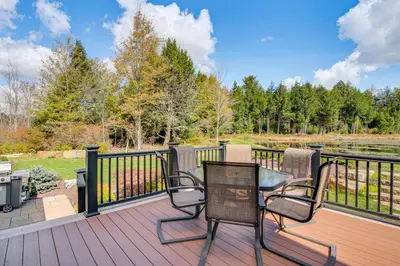 a patio with two chairs and a table on a deck at Spacious and Secluded Forksville Home Fire Pit in Forksville