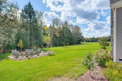 a yard with two benches in the grass at Spacious and Secluded Forksville Home Fire Pit in Forksville