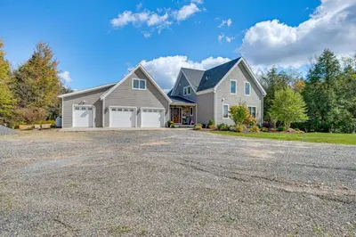 a large house with a driveway at Spacious and Secluded Forksville Home Fire Pit in Forksville