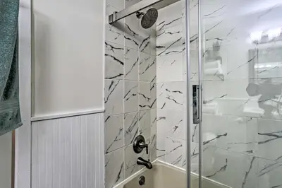 a bathroom with a shower with a glass door at Vernon Condo with Deck, Near Appalachian Trail! in Vernon Township