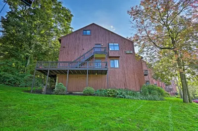 a large red barn with a balcony on it at Vernon Condo with Deck, Near Appalachian Trail! in Vernon Township