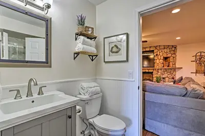 a bathroom with a sink toilet and a bedroom at Vernon Condo with Deck, Near Appalachian Trail! in Vernon Township