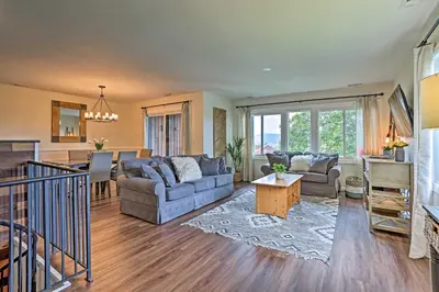 a living room with a couch and a table at Vernon Condo with Deck, Near Appalachian Trail! in Vernon Township