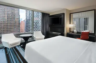 a hotel room with a large bed and a large window at Courtyard by Marriott New York Manhattan/Central Park in New York