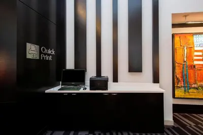 a desk with a laptop computer on top of it at Courtyard by Marriott New York Manhattan/Central Park in New York