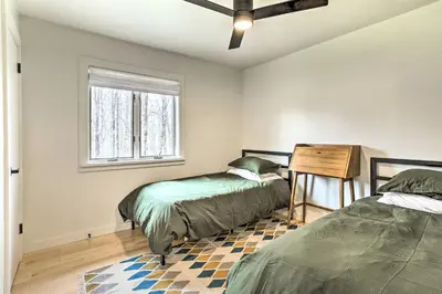 a bedroom with two beds and a window at Modern Hideaway with Deck and State Forest Access in Livingston Manor