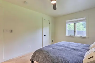 a bedroom with a bed and a window at Modern Hideaway with Deck and State Forest Access in Livingston Manor