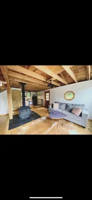 a living room with a couch and a table at The Cabin at Parkhill in Downsville
