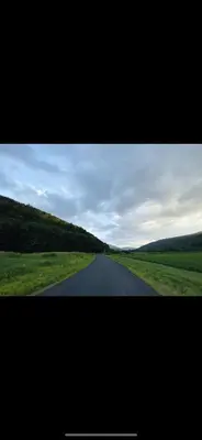 a long road in the middle of a field at The Cabin at Parkhill in Downsville