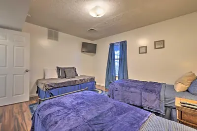 a living room with two beds and a window at Resort Perks and Lake Access Poconos Retreat in Pocono Summit