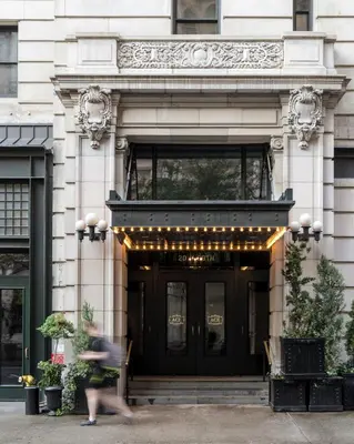 a person walking in front of a building at Ace Hotel New York in New York