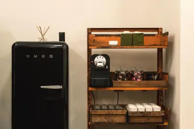 a shelf next to a black refrigerator next to a shelf withartifacts at Ace Hotel New York in New York
