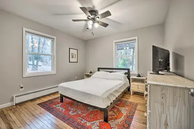 a bedroom with a bed and a flat screen tv at Game Room, Fire Pit and Deck Spacious Poconos Home! in Lake Harmony