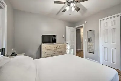 a bedroom with a bed and a ceiling fan at Game Room, Fire Pit and Deck Spacious Poconos Home! in Lake Harmony