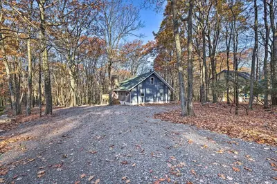 a road leading to a barn in the woods at Game Room, Fire Pit and Deck Spacious Poconos Home! in Lake Harmony