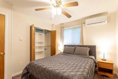 a bedroom with a bed and a ceiling fan at Cozy Poconos Ranch Home with Pool Access, Near Lake! in Gouldsboro